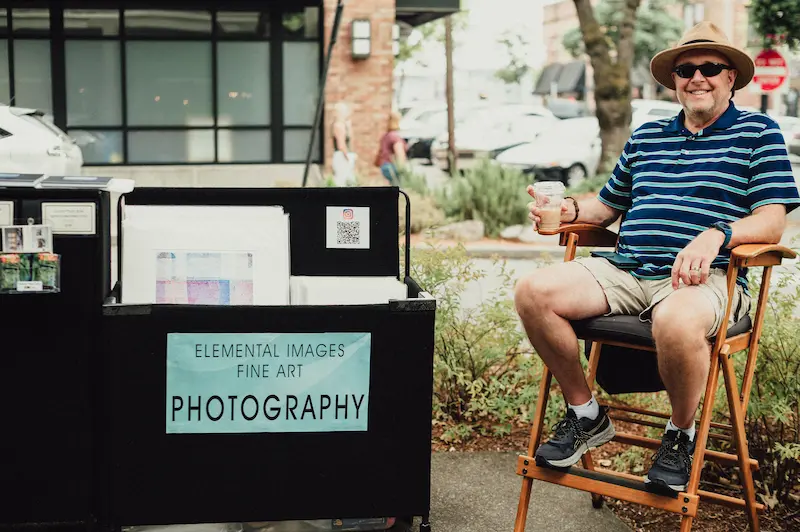 Elemental Images fine art photography booth with a local photographer greeting visitors at the Camas Art and Wine Walk.