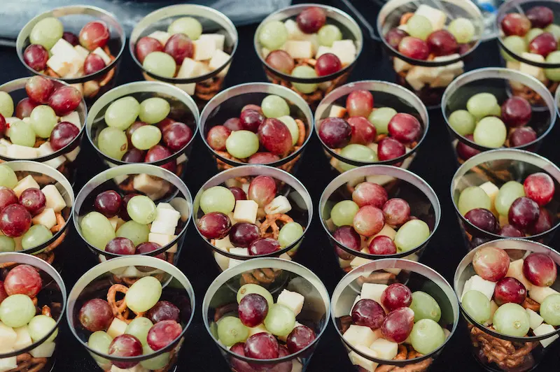 Individual snack cups filled with fresh grapes, cheese, and pretzels served at the Camas Art and Wine Walk.