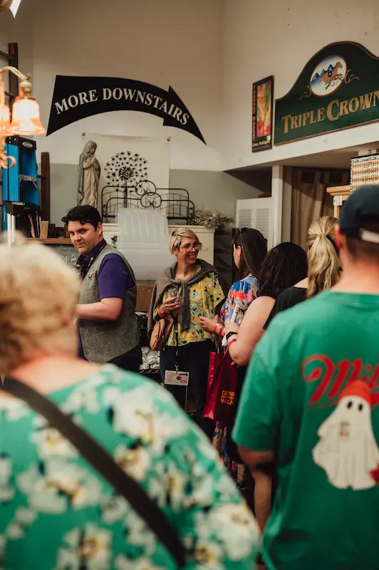 Attendees gathering and socializing inside a local Camas boutique during the annual community Art and Wine Walk.