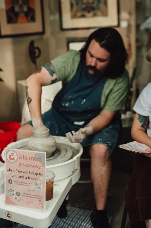 A local artisan at the à la mud booth demonstrating live pottery sculpting for guests in Downtown Camas, Washington.