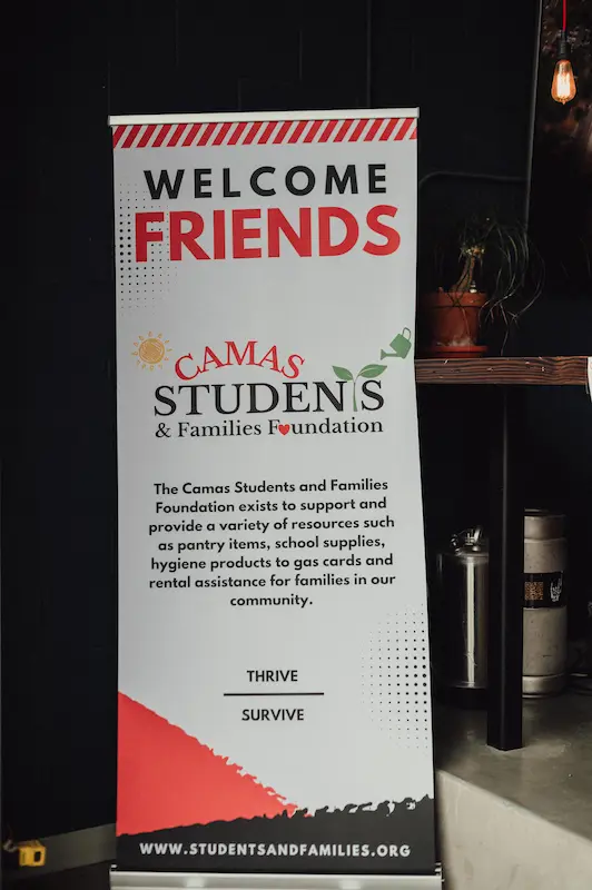 A Camas Students and Families Foundation welcome banner displayed at the entrance of Camas Art and Wine Walk in Washington.